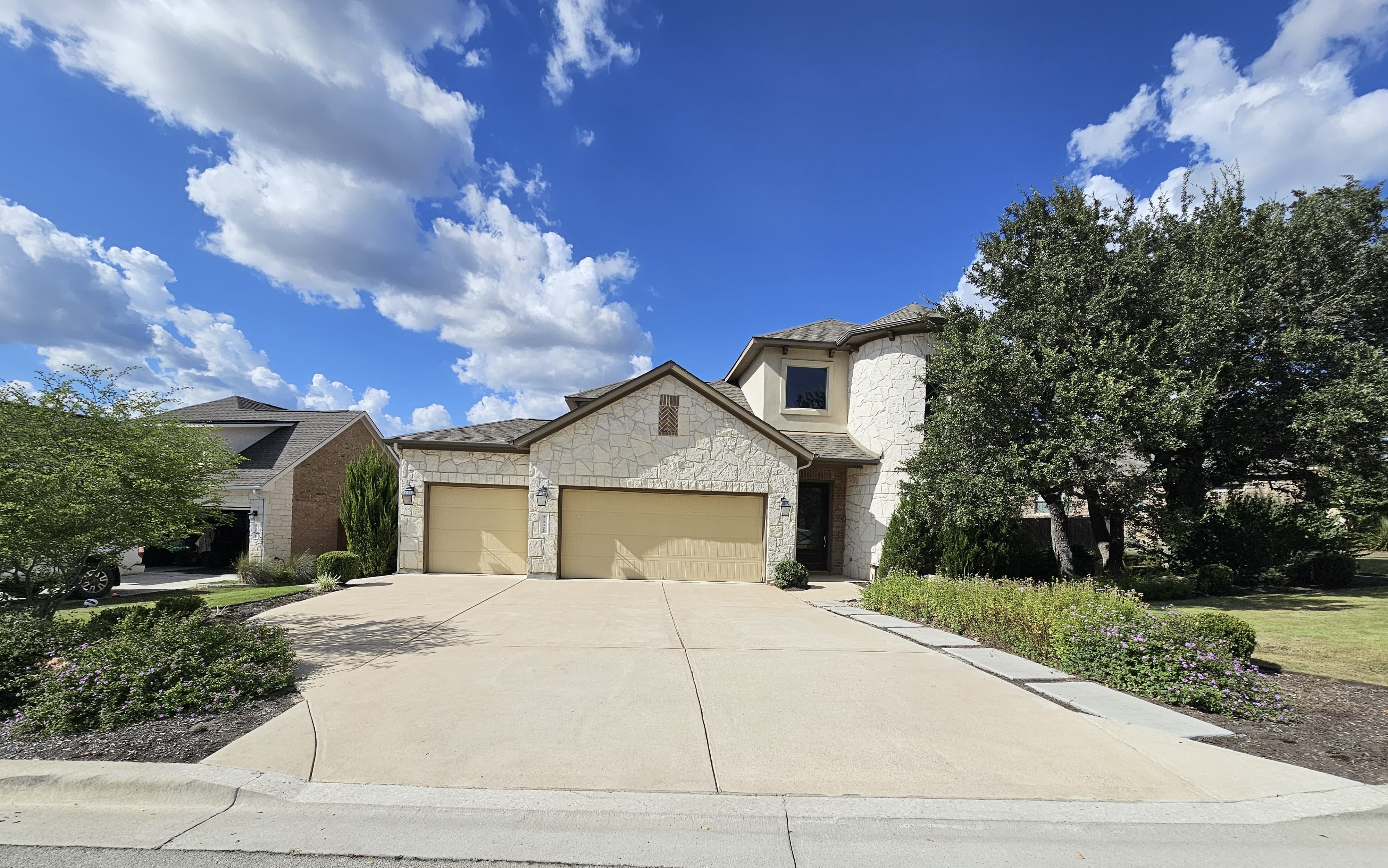 Residential power washing in progress on a home exterior, demonstrating our professional cleaning technique